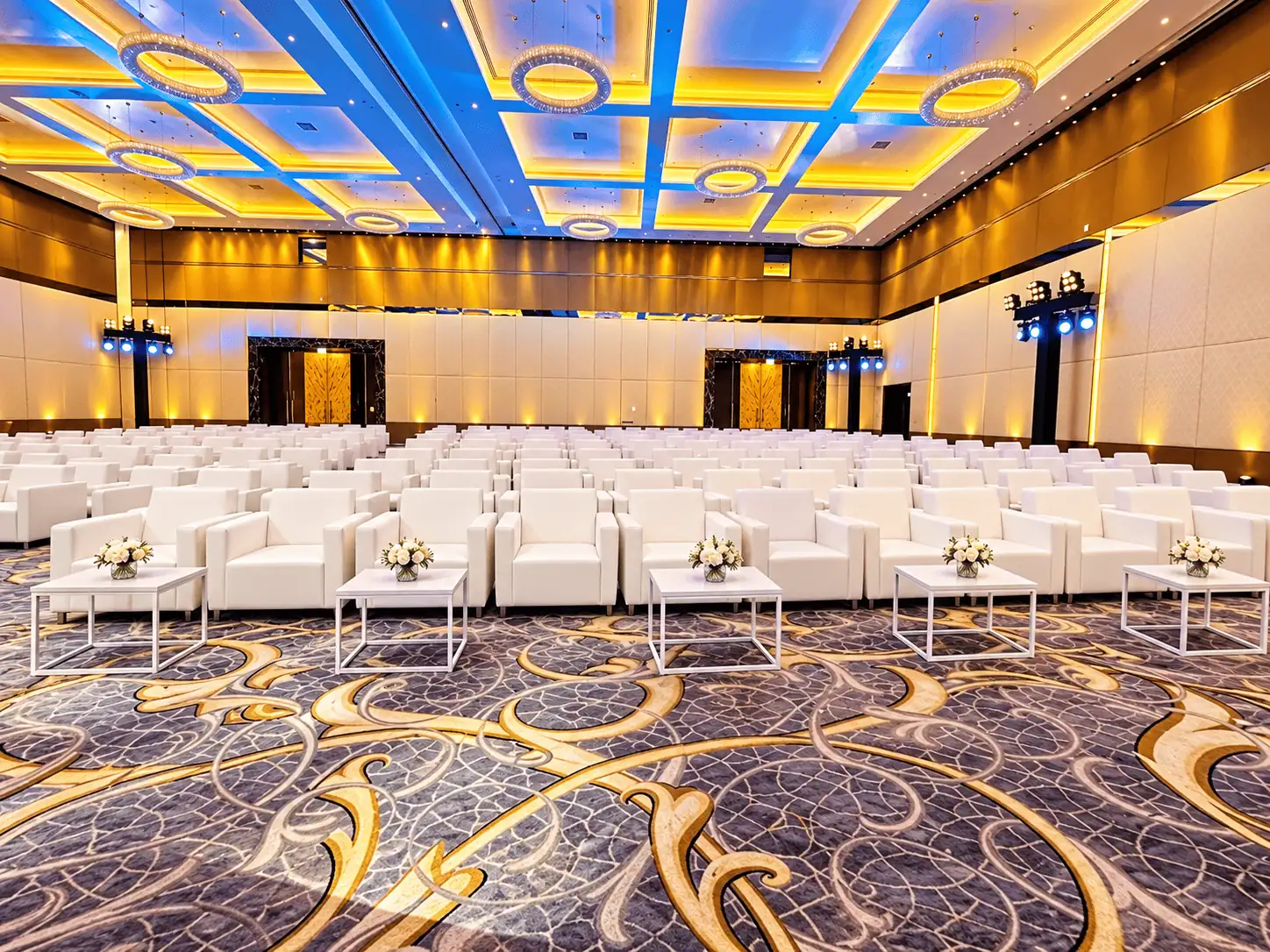 Luxury Ballroom with White Seating and Ring Chandeliers